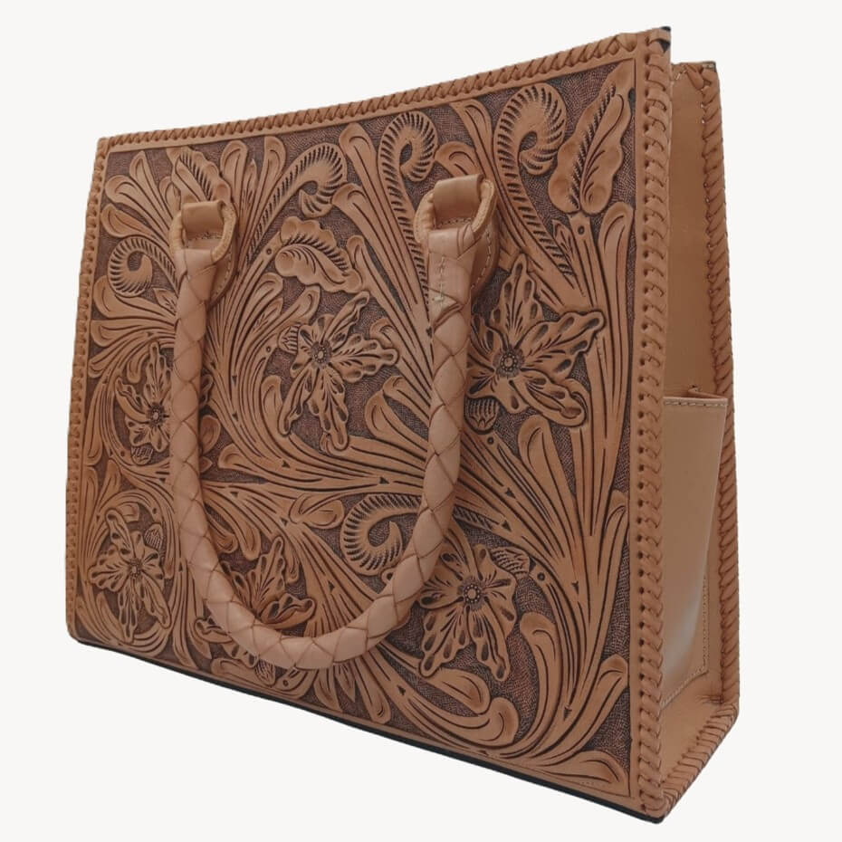 Honey-toned full-grain leather tote with intricate floral tooling and rolled handles
