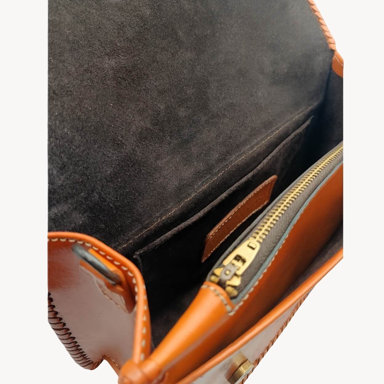 Interior view with suede lining, zip pocket, and slip pocket on Crimson Legacy handbag