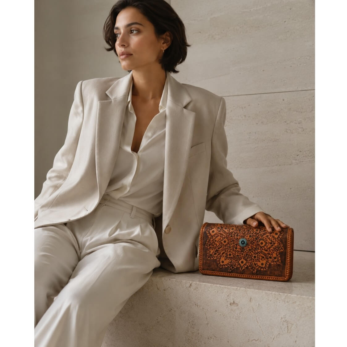 Premium brown leather clutch purse with floral mandala artwork and decorative burnt orange accent clasp