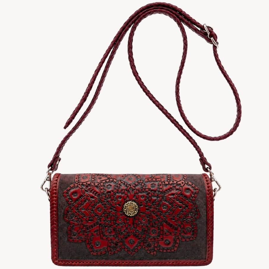 Mahogany Espresso embossed leather crossbody bag with mandala detailing, braided shoulder strap, silver hardware, and gold circular clasp.