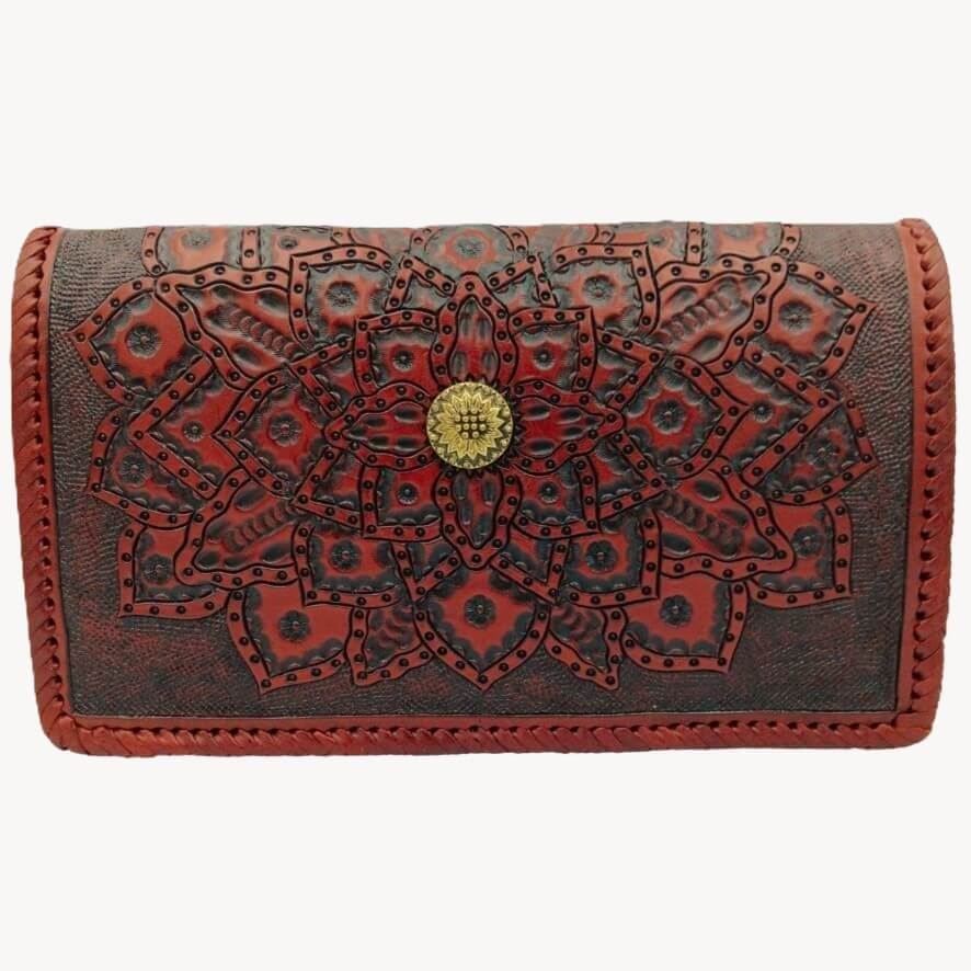 Brown leather wallet with intricate red floral design on a white background