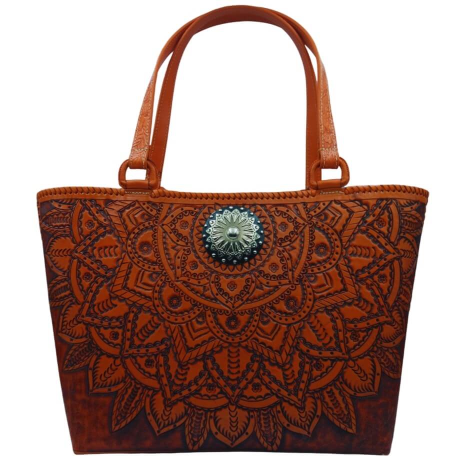 Upright front view of handmade full‑grain leather tote with mandala tooling.