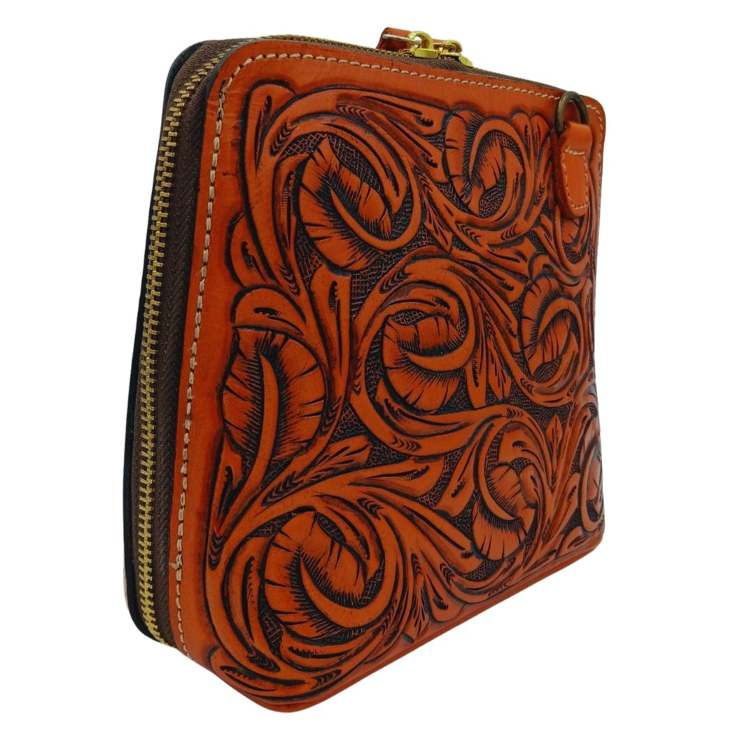 Side profile showing depth and secure top zip closure on leather crossbody