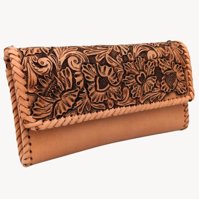 Angled right view of hand‑tooled leather purse with magnetic flap.