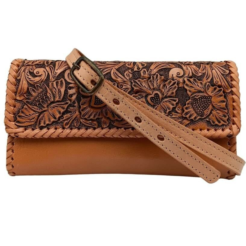 Clutch with adjustable removable crossbody strap laid across the front.