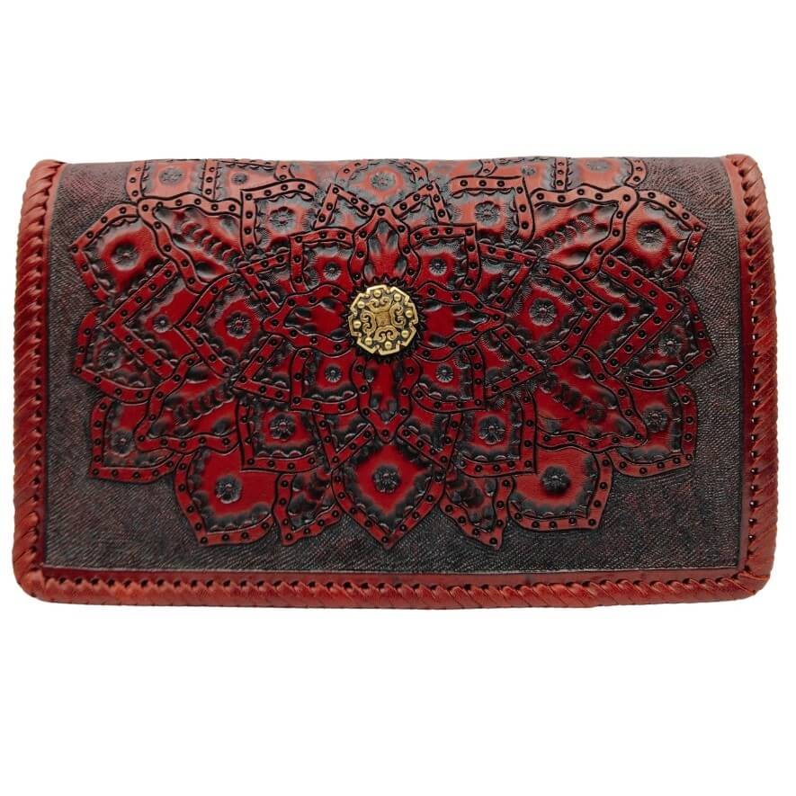 Front view of hand‑tooled full‑grain leather crossbody with embossed mandala and brass concho in deep crimson.