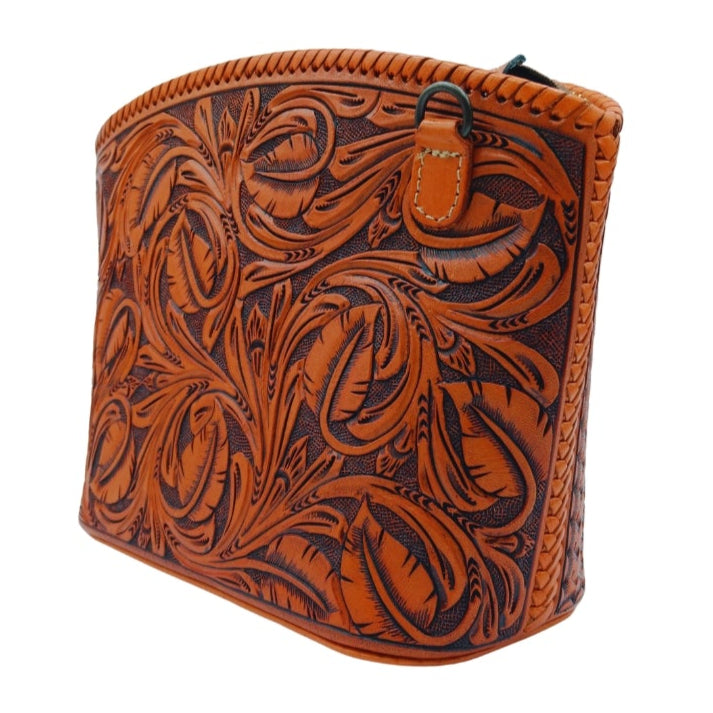 Angled view—hand‑tooled leather crossbody with removable strap tab—Miohermosa