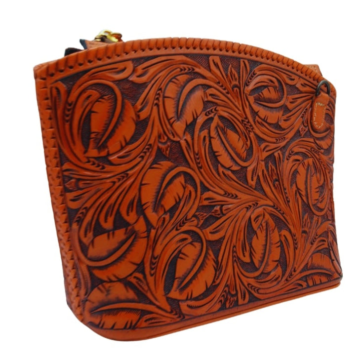 Angled view—hand‑tooled leather crossbody with removable strap tab—Miohermosa