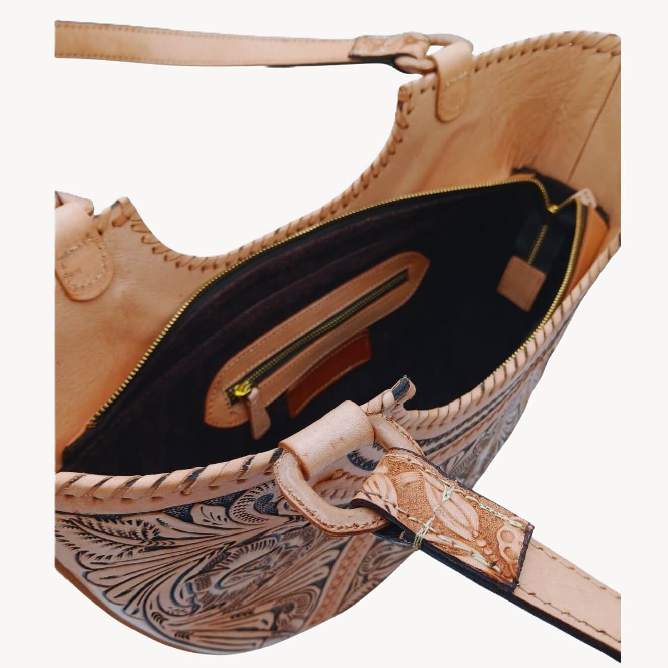 Interior of Flor de Cordoba Full Grain Tooled Satchel showing zip pocket and two slip pockets