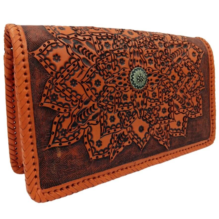 Tooled leather purse with layered mandala petals and hand‑laced edges—angled view