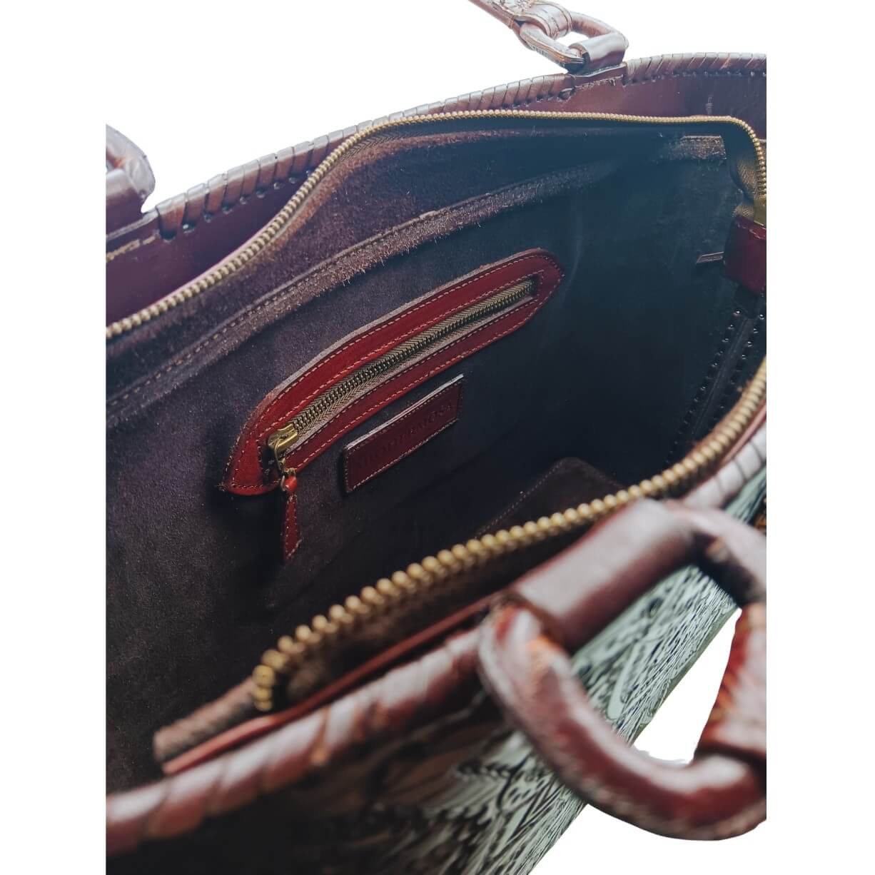 Interior—suede lining with zip pocket and two slip pockets; zip‑top closure, Mahogany Espresso.