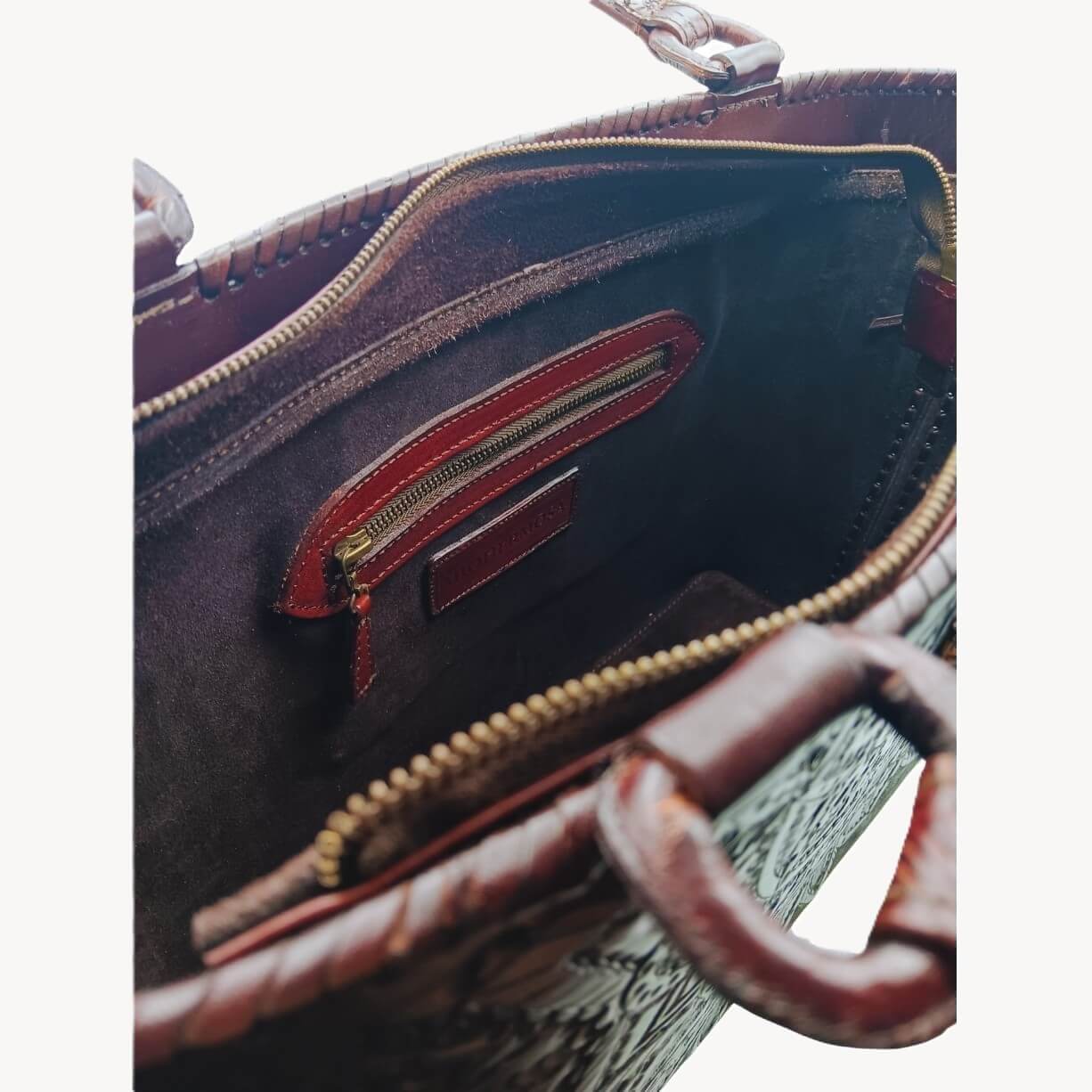 Interior—suede lining with zip pocket and two slip pockets; zip‑top closure, Mahogany Espresso.