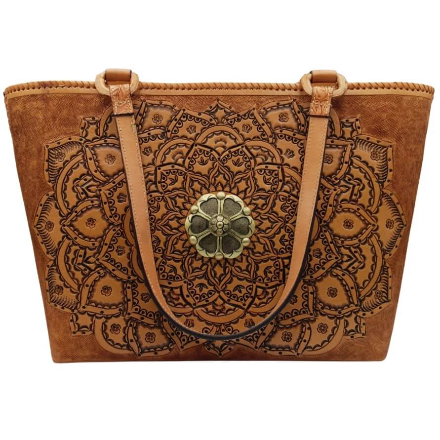 Full‑grain leather tote with embossed mandala and brass medallion, front view.