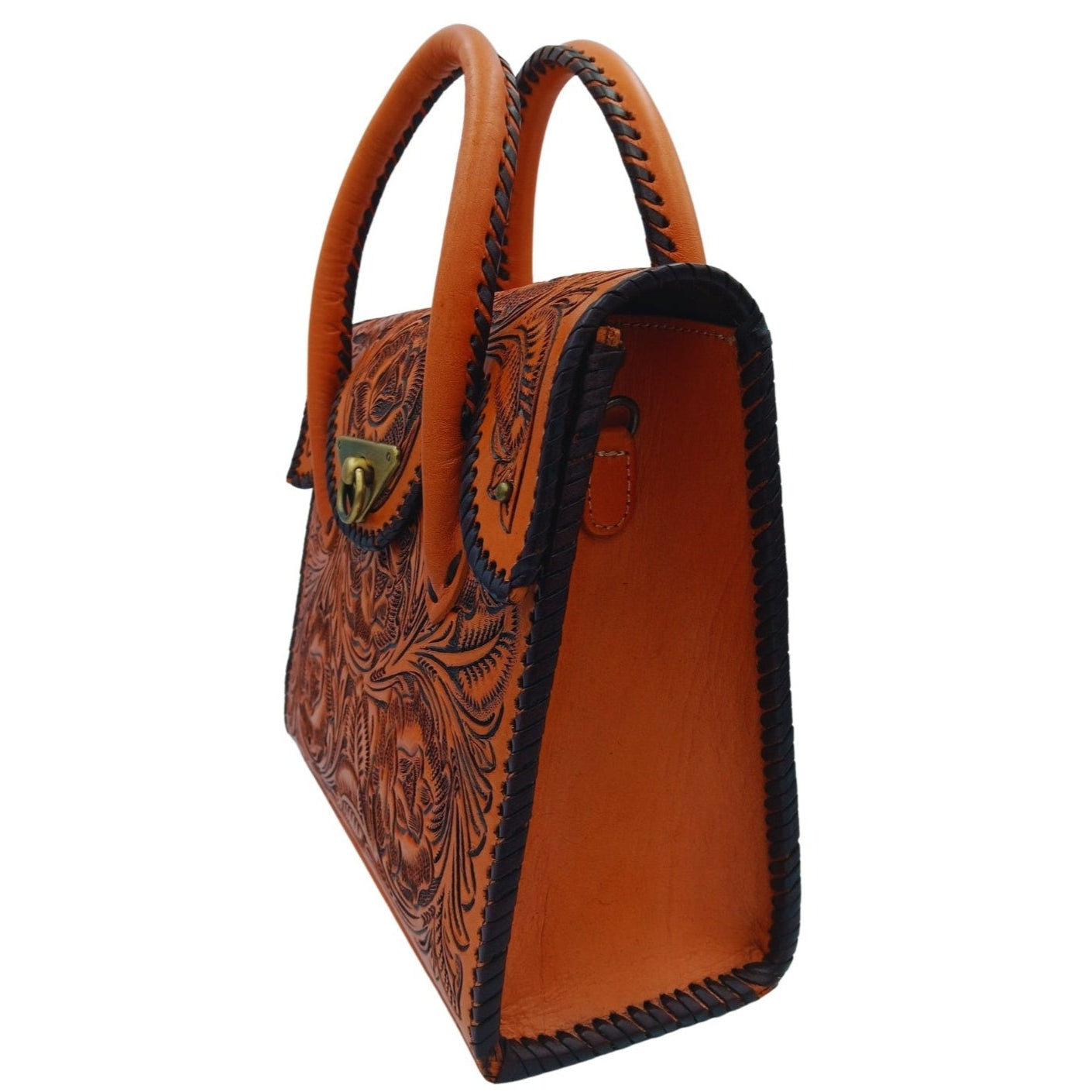 Side profile showing whipstitched edges and top handles of the hand‑tooled Full Grain Leather mini tote