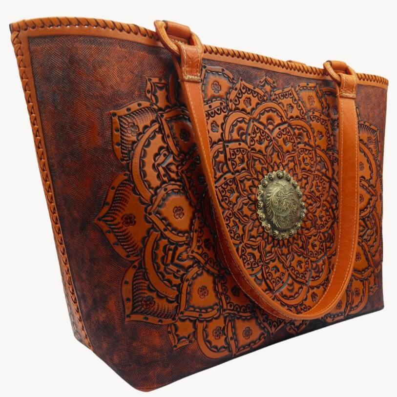 Angle showing mandala tooling, hand‑laced rim, and shoulder handles.
