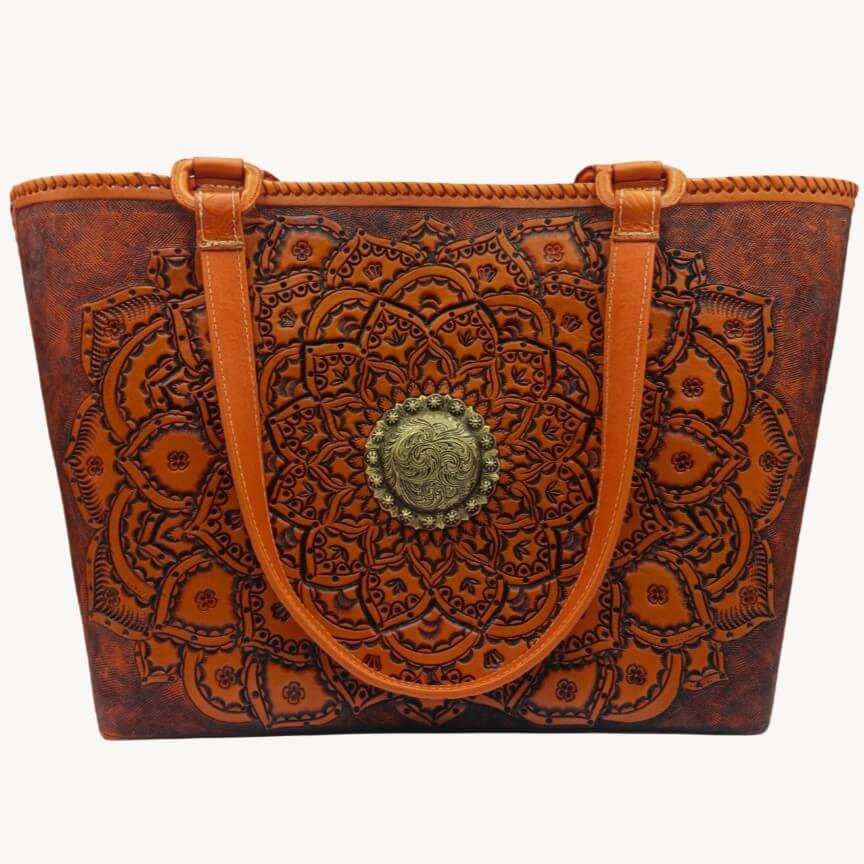 Front view of Sol de Oro full grain leather tote with hand‑tooled mandala and brass concho.
