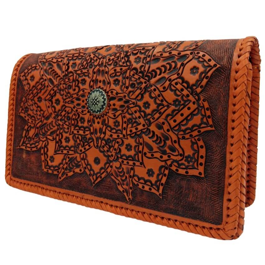 Handmade handbag in burnt orange full‑grain leather—mandala tooling detail