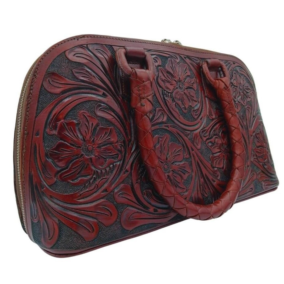 Tooled leather purse in deep burgundy left three quarter view