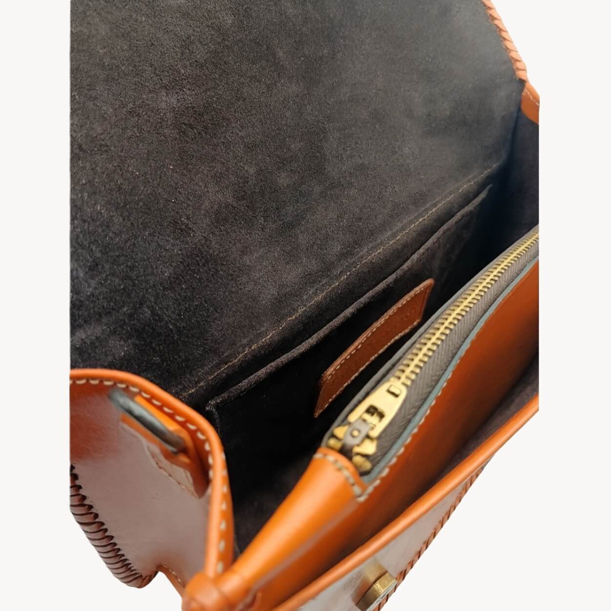 Interior of Sedona Mandala Tooled Leather Crossbody with suede lining, zip pocket, and slip pocket burnt orange