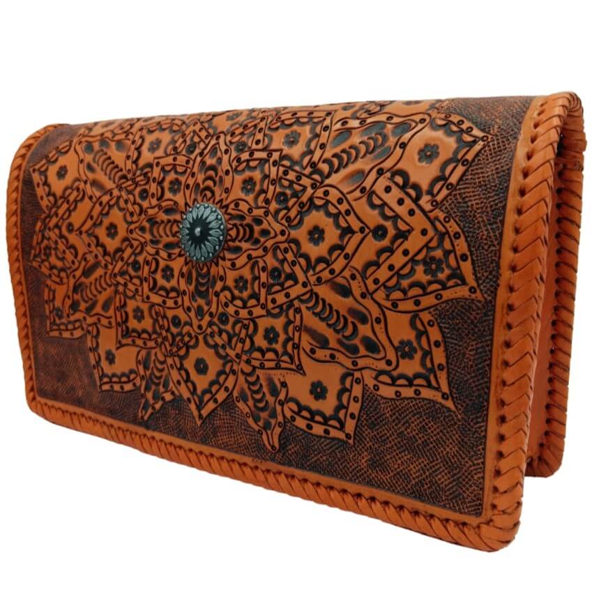 Three-quarter view of Sedona Mandala Tooled Leather Crossbody with sunflower medallion center design burnt orange