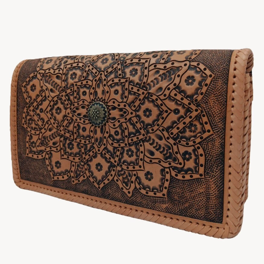 Three‑quarter right view of tooled leather crossbody highlighting layered mandala petals.