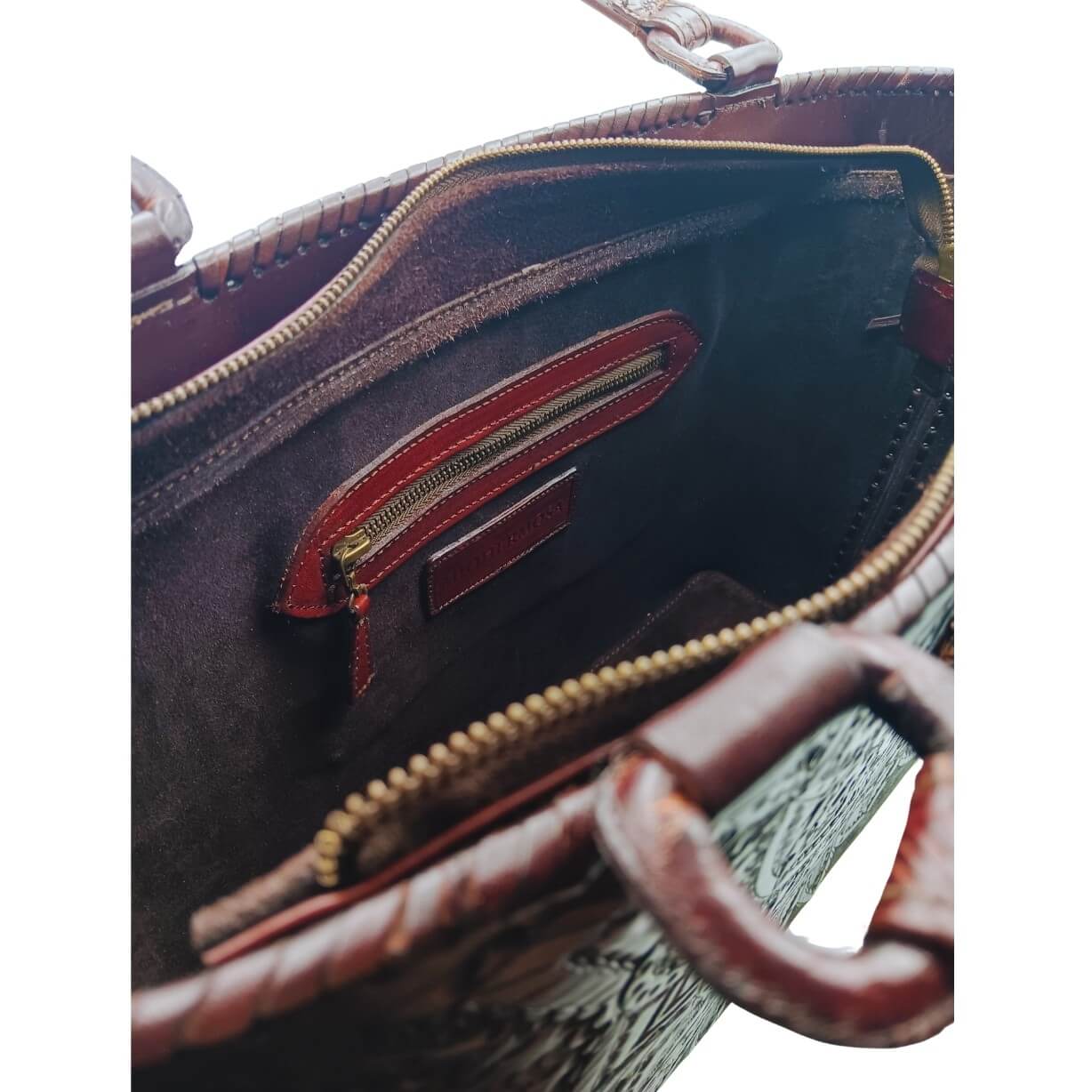 Suede‑lined leather purse interior with zip pocket and two slip pockets.