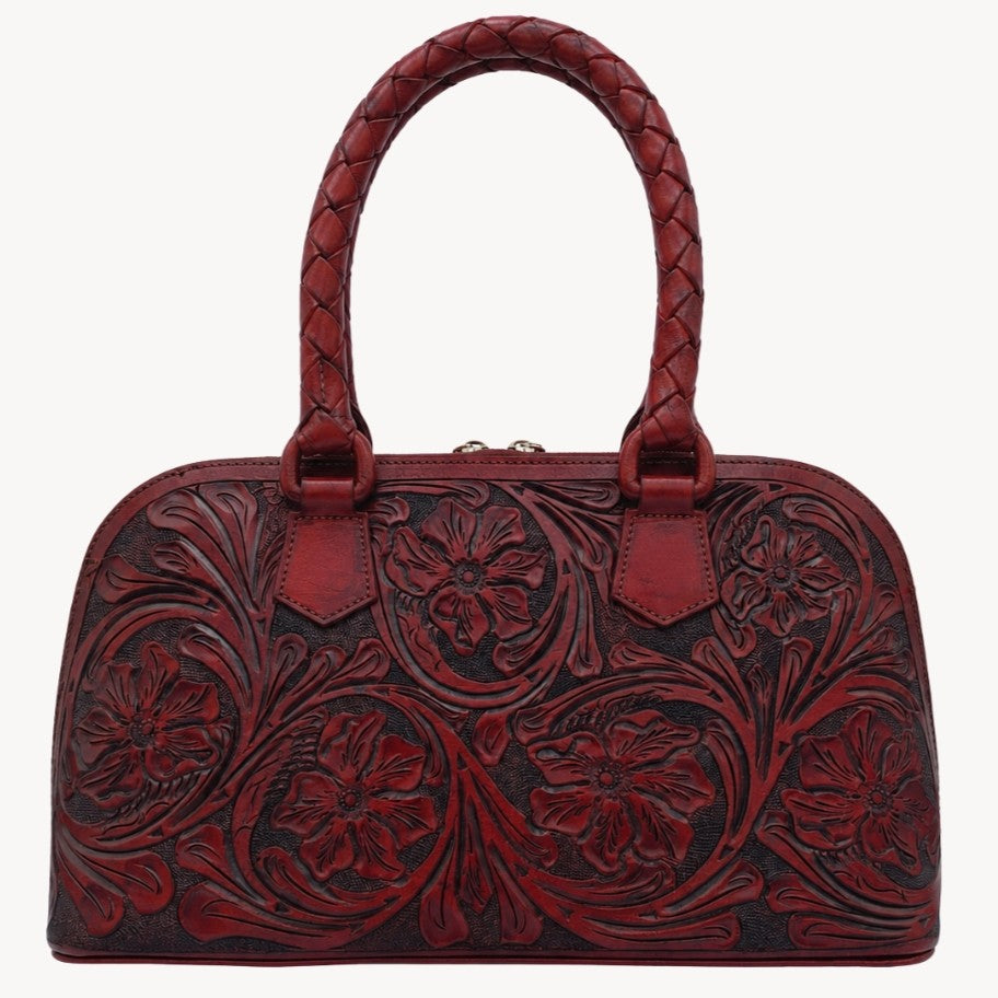 Mahogany Espresso hand-tooled leather satchel bag with floral detailing, braided top handles, and structured silhouette.