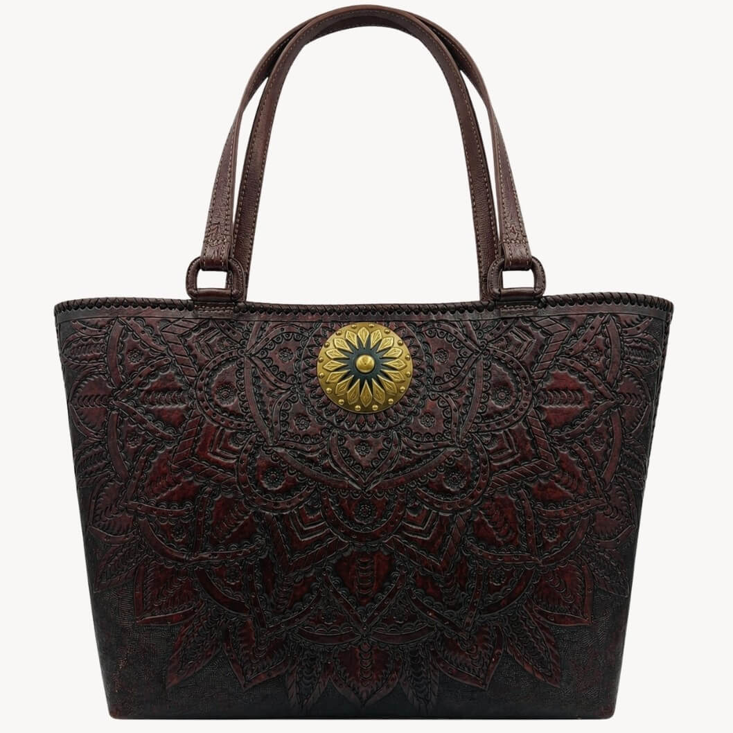 Mahogany espresso mandala embossed leather tote handbag with top handles and a round gold medallion.
