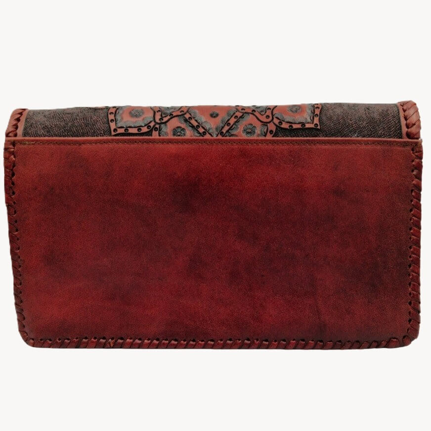 Red leather wallet with patterned flap on a white background