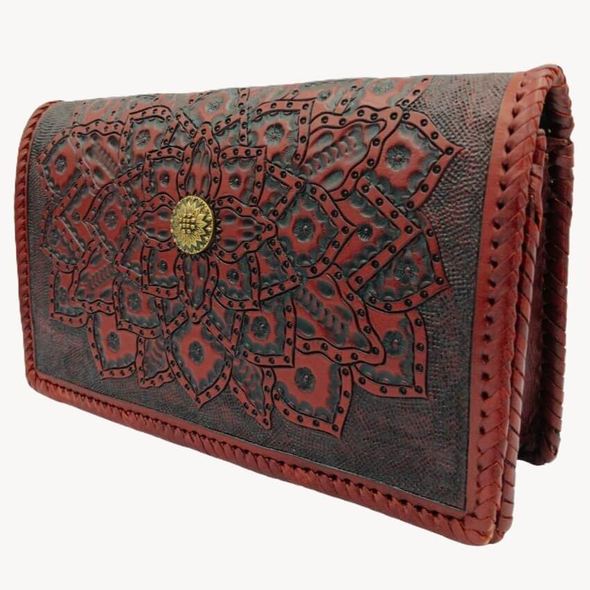 Brown leather wallet with intricate red floral design and gold emblem on a white background