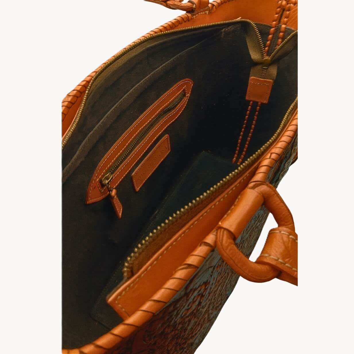 Interior suede lining with zip pocket and slip pockets inside leather tote.