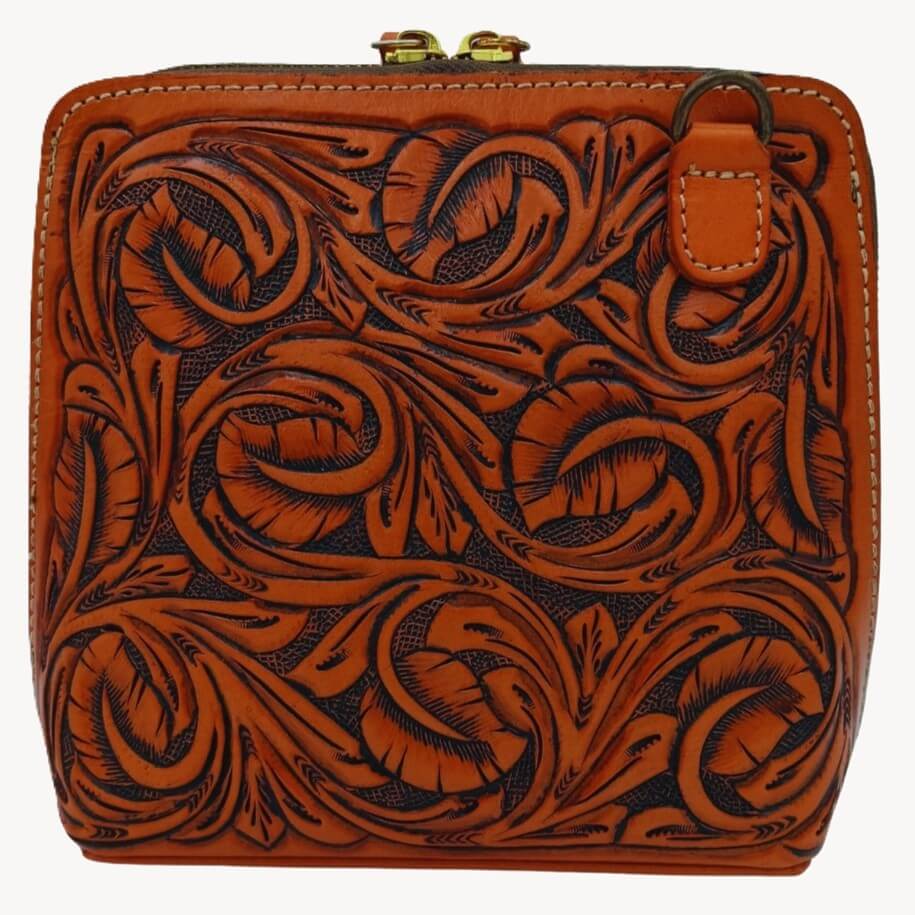 Hand‑tooled full‑grain leather crossbody, front filigree/leaf tooling