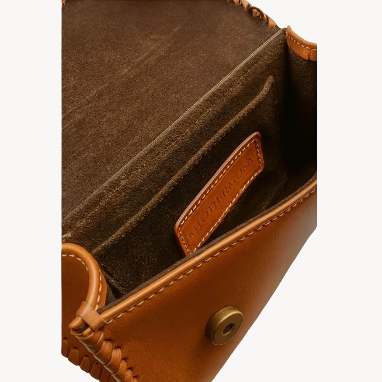 Interior view showing side pocket, suede‑like lining, and magnetic closure.
