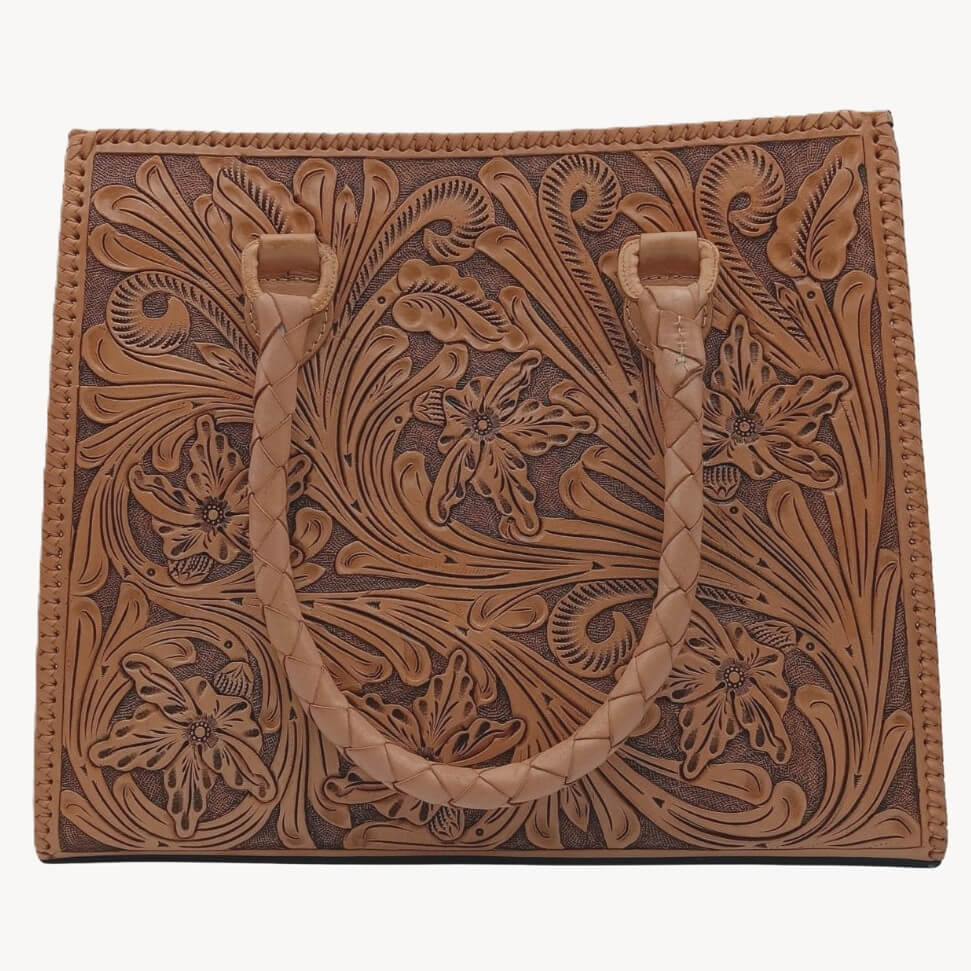Flor de Miel Heritage Tote — hand‑tooled full‑grain leather floral design with braided handles