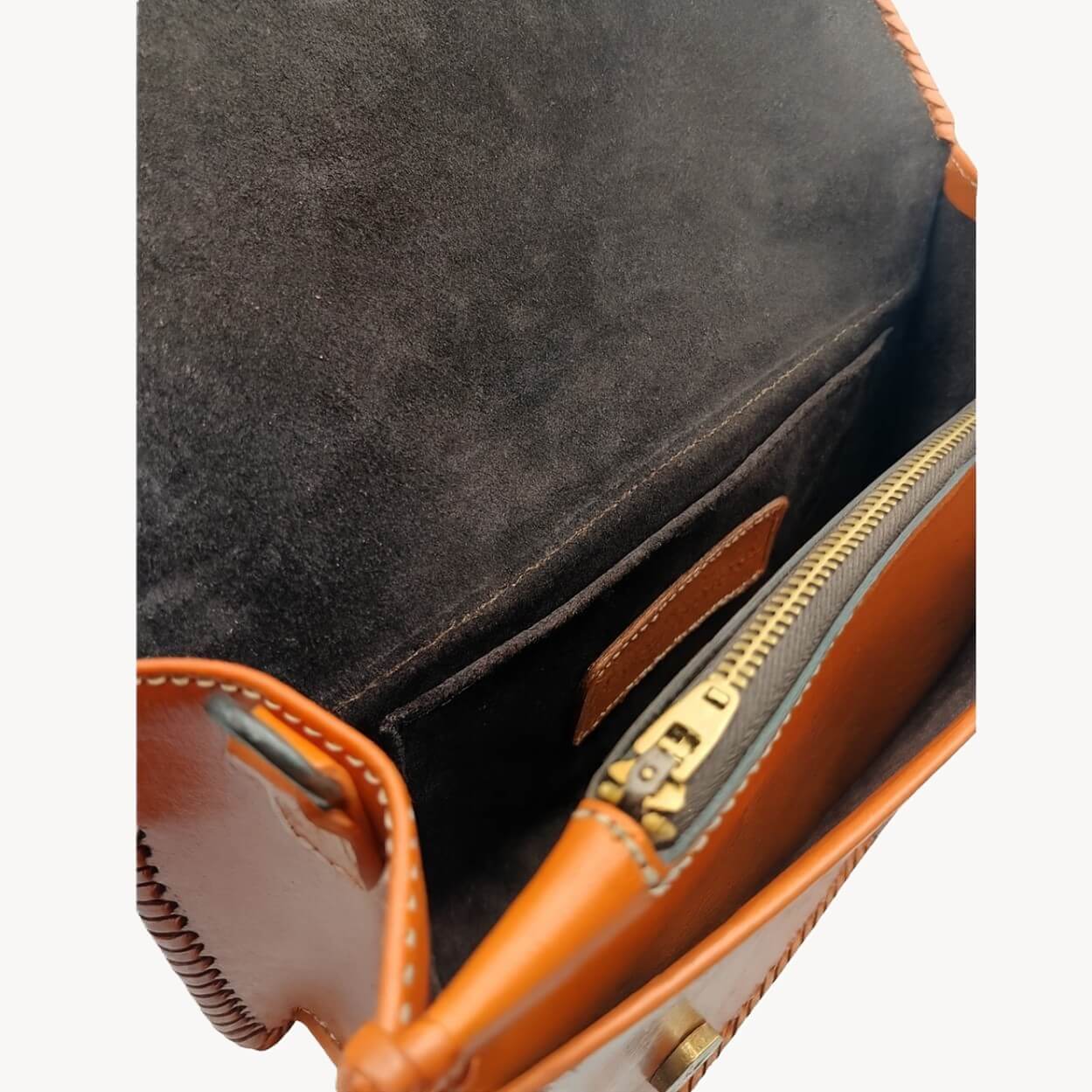 Suede‑lined interior with zip pocket, slip pocket, and D‑rings—handmade leather purse