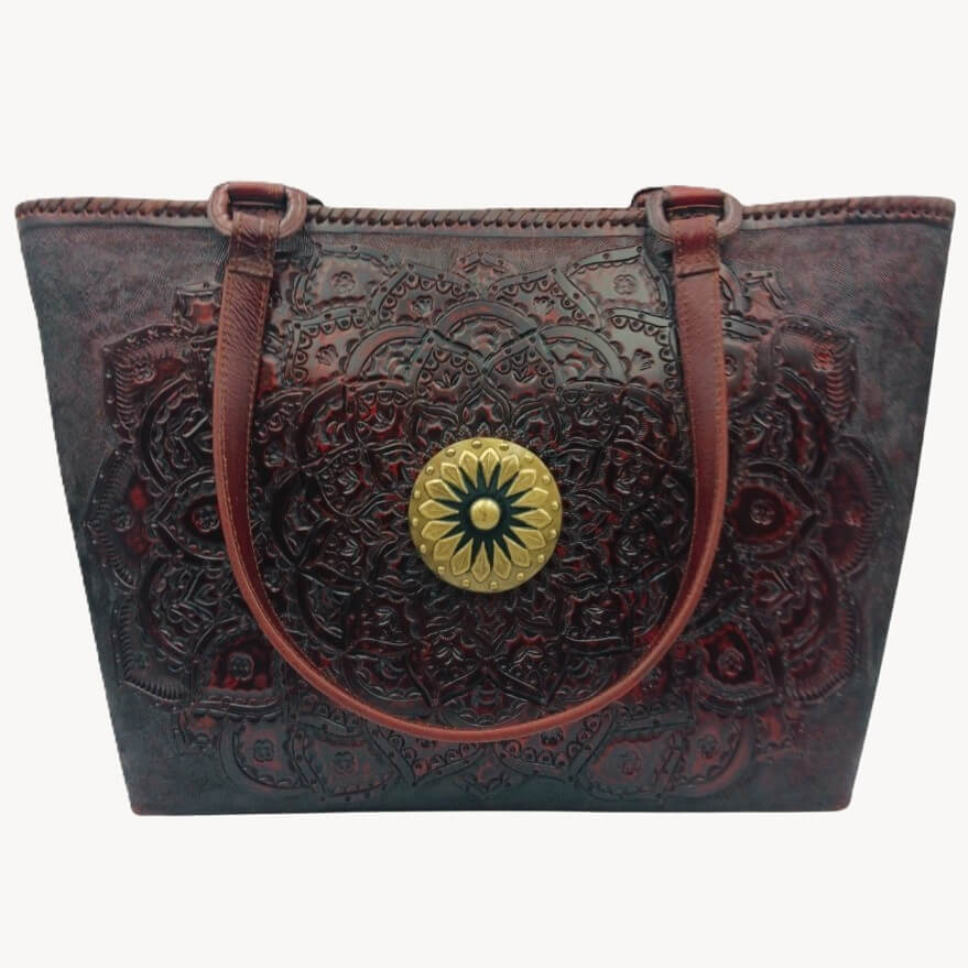 Front view—hand‑tooled full grain leather tote with mandala rosette and brass concho, cognac, Mahogany Espresso.