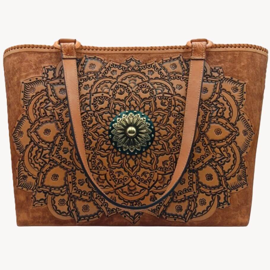 Front view—hand‑tooled full grain leather tote with mandala rosette and brass concho, cognac.
