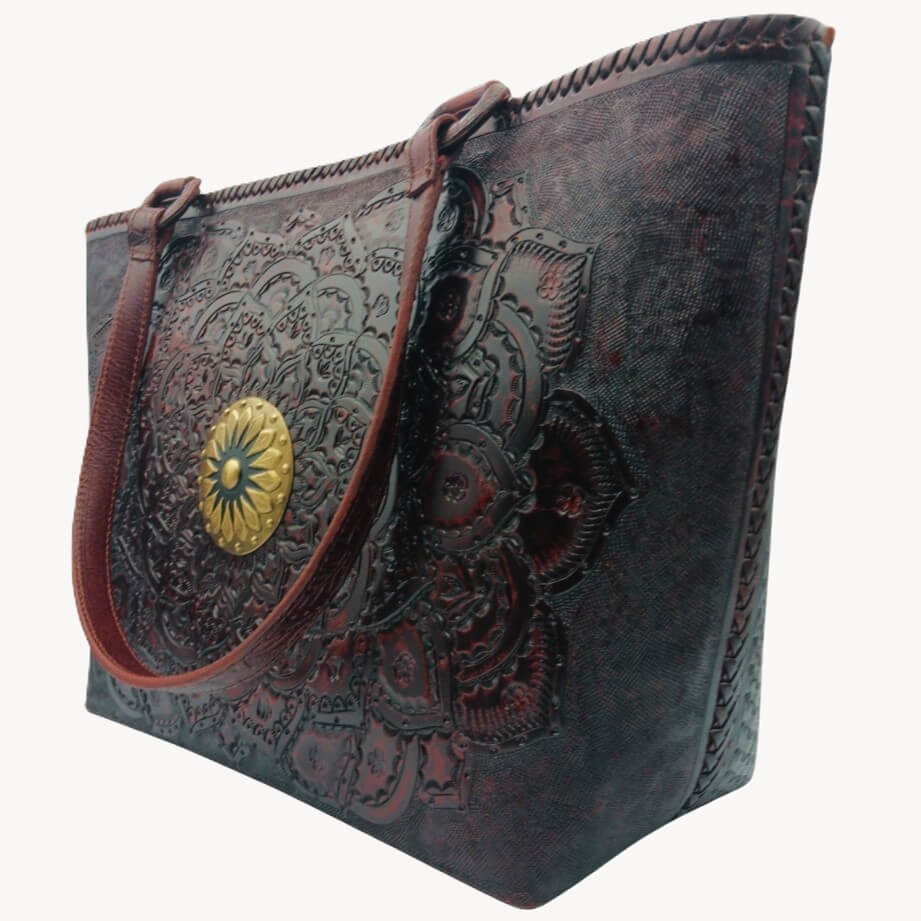 Angled right—mandala tooling and hand‑laced side on full‑grain leather tote, Mahogany Espresso. 