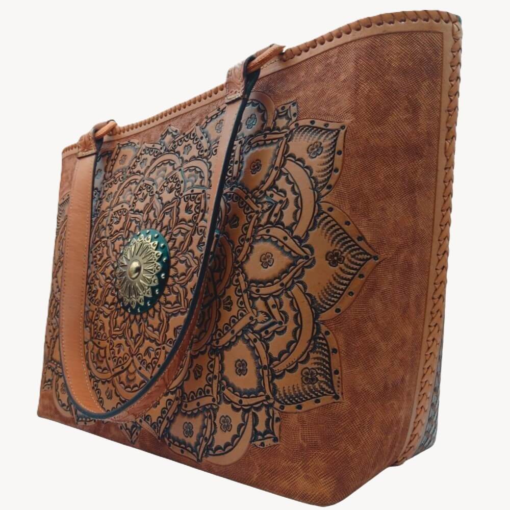 Angled right—mandala tooling and hand‑laced side on full‑grain leather tote.