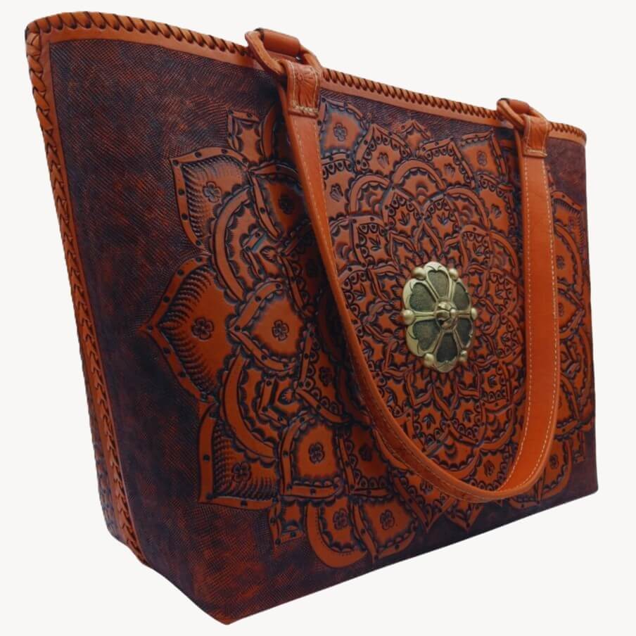 Full‑grain leather mandala tote, angled right, floral handles detail.