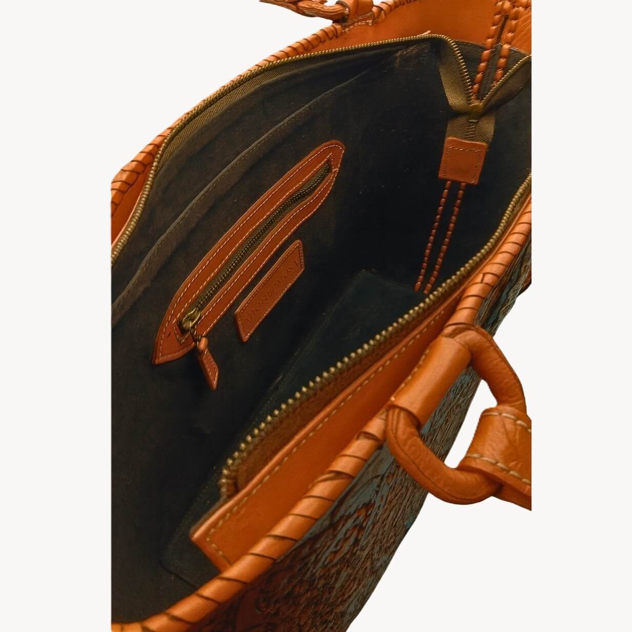 Suede‑lined interior with zip pocket and two slip pockets, zip closure.