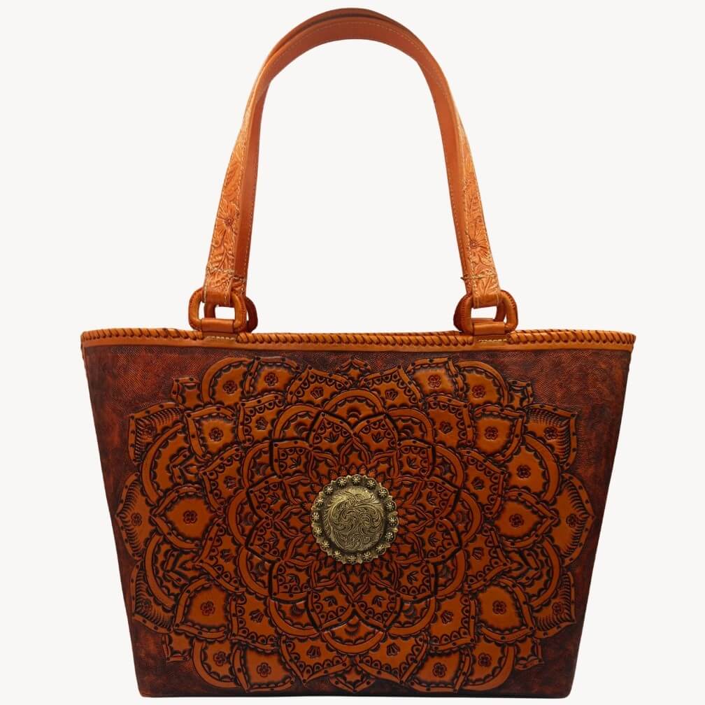 Close view of tooled handles and hand‑laced rim on leather tote.