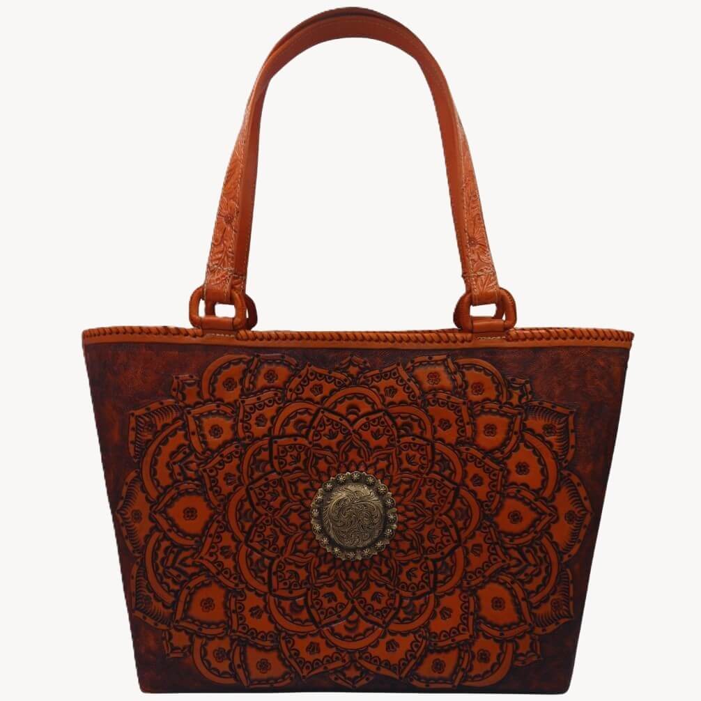 Close view of tooled handles and hand‑laced rim on leather tote.