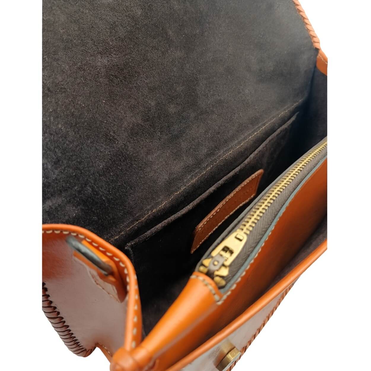 Interior of Sedona Mandala Tooled Leather Crossbody with suede lining, zip pocket, and slip pocket burnt orange