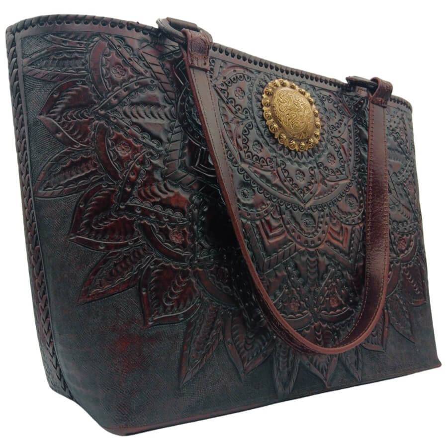 Hand‑tooled mandala leather purse, side angle showing whipstitched edge.